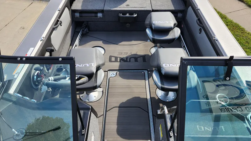 Slide: The Image of 2025 Lund 1875 Tyee boat interior with seating and steering wheel. - 11