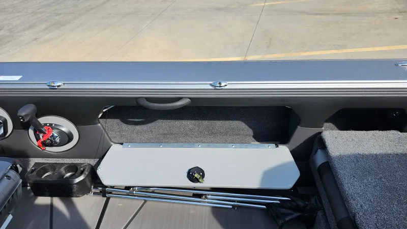 Slide: The Image of 2025 Lund 1875 Tyee boat interior with storage compartment and cup holders. - 12