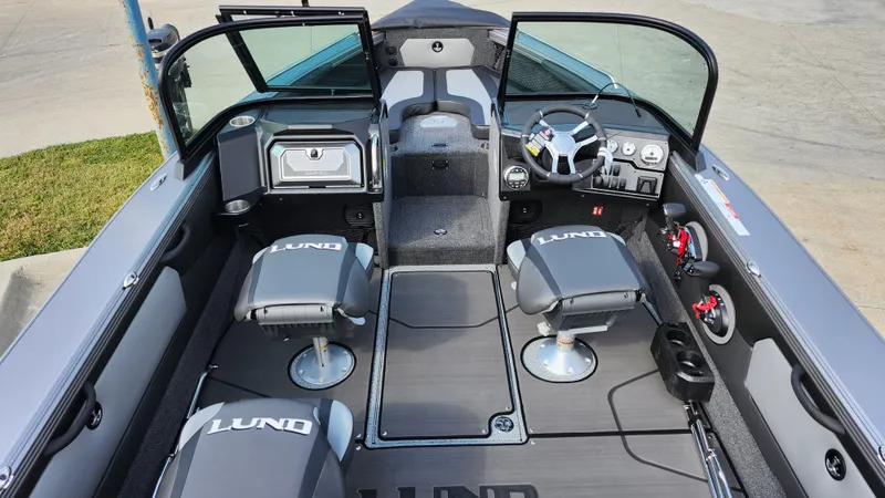 Slide: The Image of 2025 Lund 1875 Tyee boat interior with seating and steering console. - 13