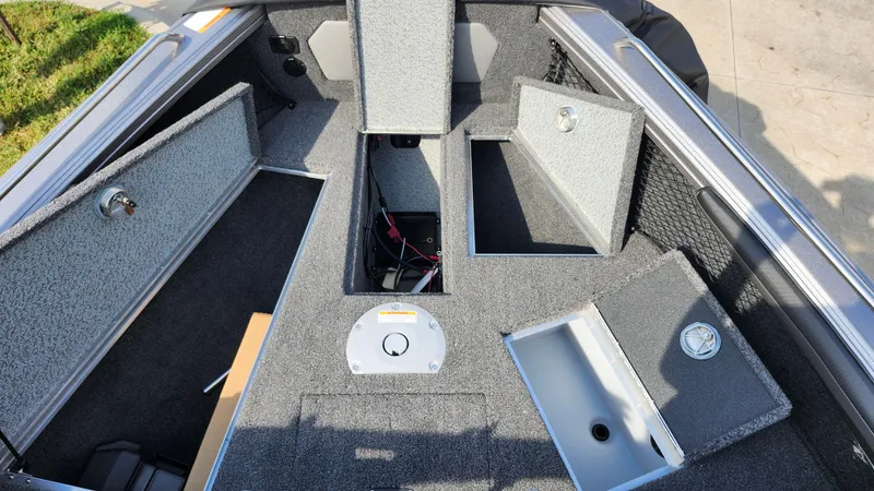 Slide: The Image of 2025 Lund 1875 Tyee boat interior with open storage compartments. - 15