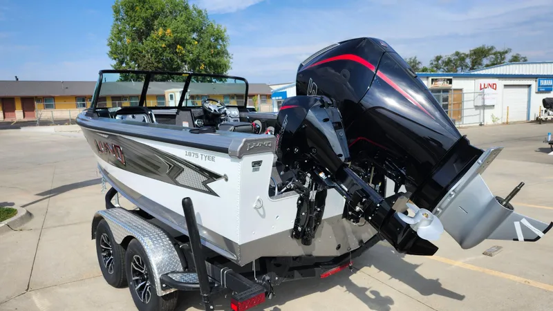 Slide: The Image of 2025 Lund 1875 Tyee boat on trailer, featuring powerful outboard motor. - 17