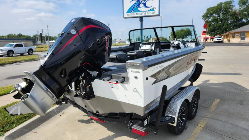 Slide: The Image of 2025 Lund 1875 Tyee boat with powerful outboard motor in parking lot. - 19