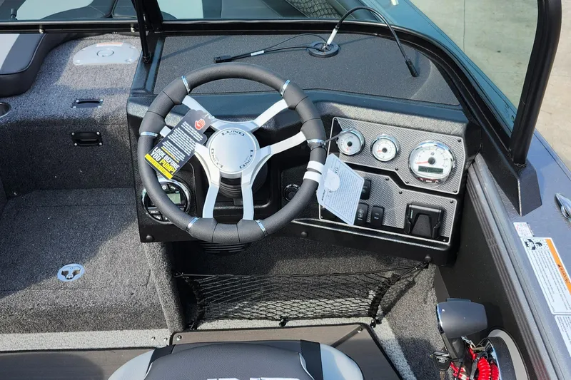 Slide: The Image of 2025 Lund 1875 Tyee boat dashboard with steering wheel and instrument panel. - 21