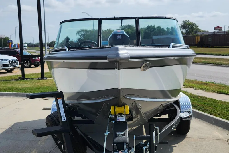 Slide: The Image of 2025 Lund 1875 Tyee boat on trailer, parked outdoors. - 22