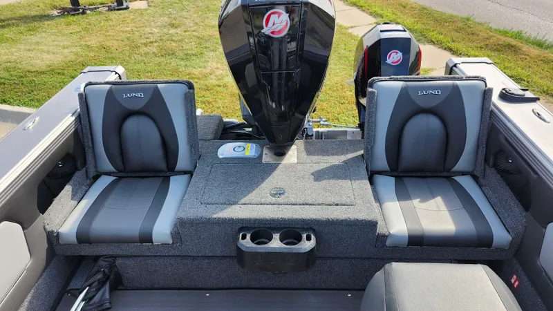 Slide: The Image of 2025 Lund 1875 Tyee boat interior with dual seats and motor. - 9