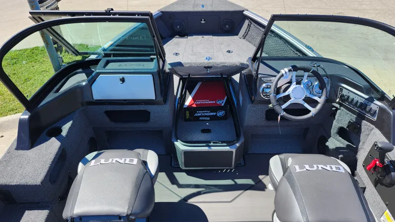 Slide: The Image of 2025 Lund 1775 Impact XS Sport boat interior with steering wheel and seating. - 10