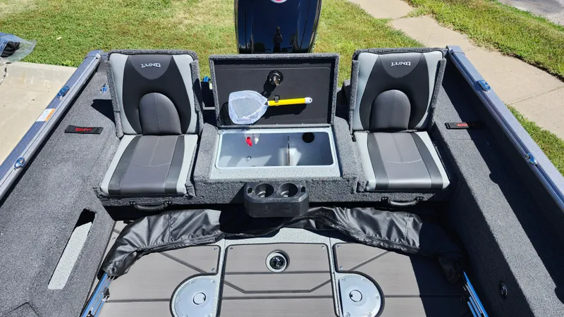 Slide: The Image of 2025 Lund 1775 Impact XS Sport boat interior with seating and storage compartments. - 11