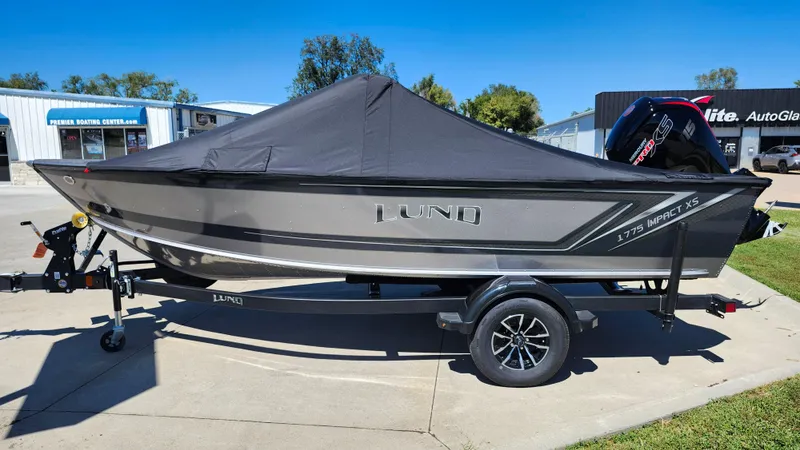Slide: The Image of 2025 Lund 1775 Impact XS Sport boat with cover on trailer. - 12