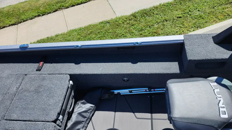 Slide: The Image of 2025 Lund 1775 Impact XS Sport boat interior with seating and storage. - 14