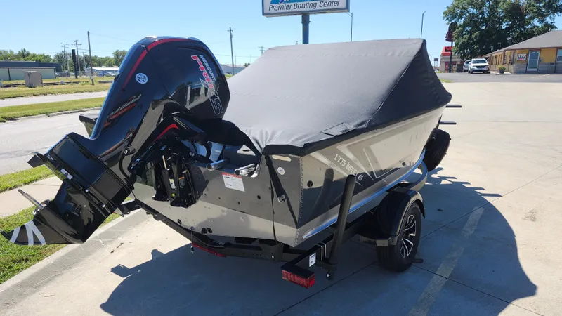 Slide: The Image of 2025 Lund 1775 Impact XS Sport boat with cover and outboard motor. - 16