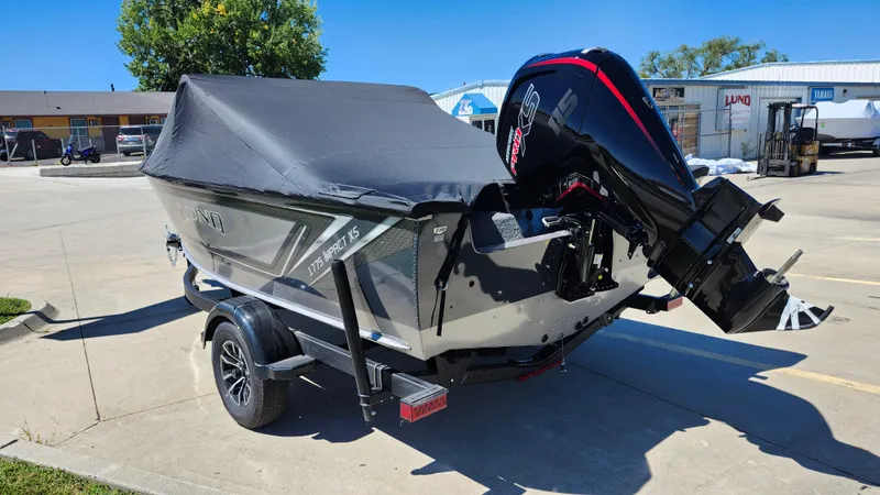 Slide: The Image of 2025 Lund 1775 Impact XS Sport boat with cover and outboard motor. - 18