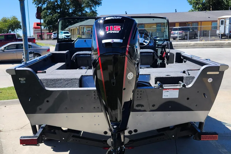 Slide: The Image of 2025 Lund 1775 Impact XS Sport boat with Mercury 115 engine, parked outdoors. - 20
