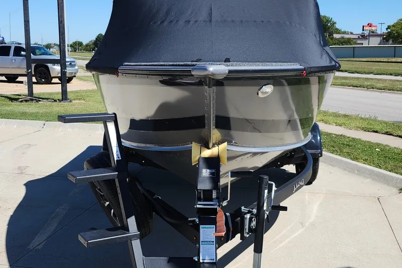 Slide: The Image of 2025 Lund 1775 Impact XS Sport boat on trailer, covered and parked outdoors. - 23