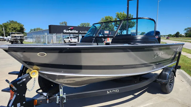Slide: The Image of 2025 Lund 1775 Impact XS Sport boat on trailer, parked outdoors. - 4