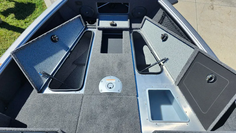 Slide: The Image of 2025 Lund 1775 Impact XS Sport boat interior with open storage compartments. - 8