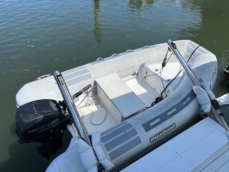 Slide: The Image of Inflatable boat with Mercury outboard motor docked on calm water. - 12