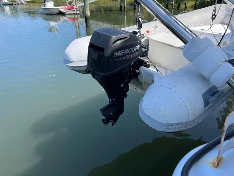 Slide: The Image of Mercury outboard motor on a Lagoon 420 catamaran, 2007 model, docked in calm waters. - 13