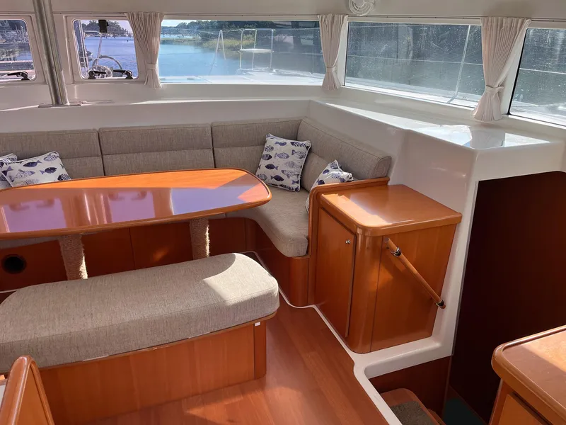 Slide: The Image of Interior of 2007 Lagoon 420 yacht with cozy seating and wooden table. - 22