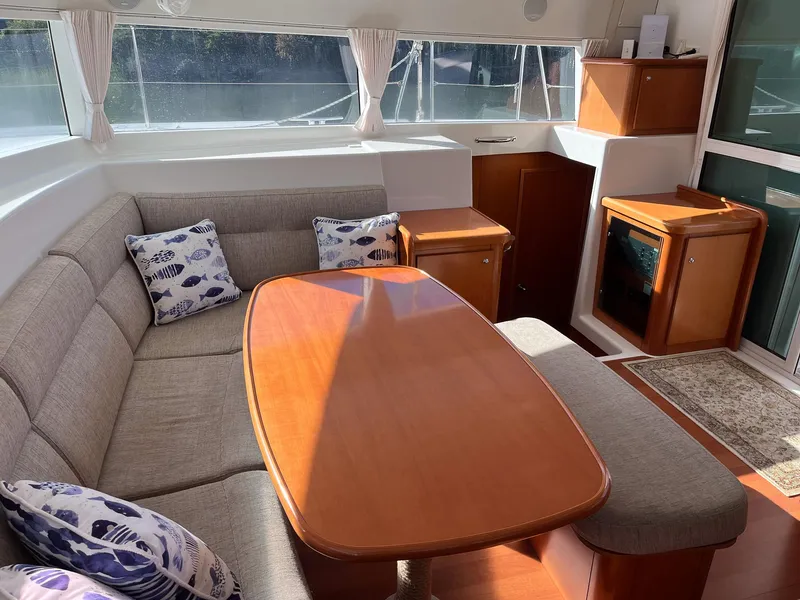 Slide: The Image of Interior of 2007 Lagoon 420 yacht with cozy seating and wooden table. - 23