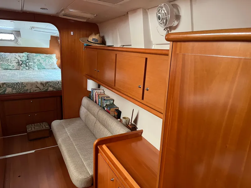 Slide: The Image of Interior of 2007 Lagoon 420 yacht with wooden cabinetry and cozy seating area. - 25