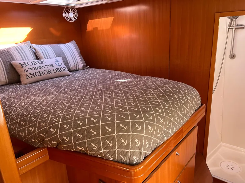Slide: The Image of Cozy bedroom in 2007 Lagoon 420 yacht with nautical-themed bedding and shower. - 26