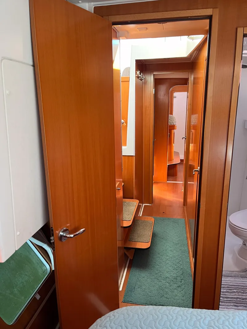 Slide: The Image of Interior view of 2007 Lagoon 420 yacht with wooden doors and cozy cabin. - 28