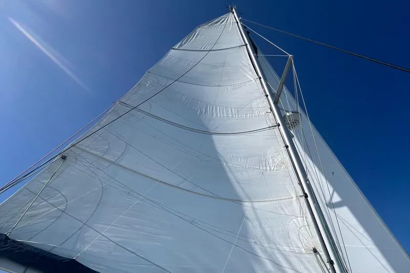 Slide: The Image of Sail of 2007 Lagoon 420 catamaran against clear blue sky. - 45