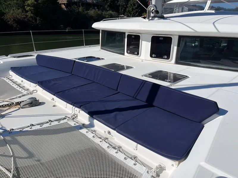 Slide: The Image of Lagoon 420 catamaran 2007 with blue deck cushions and netting. - 6