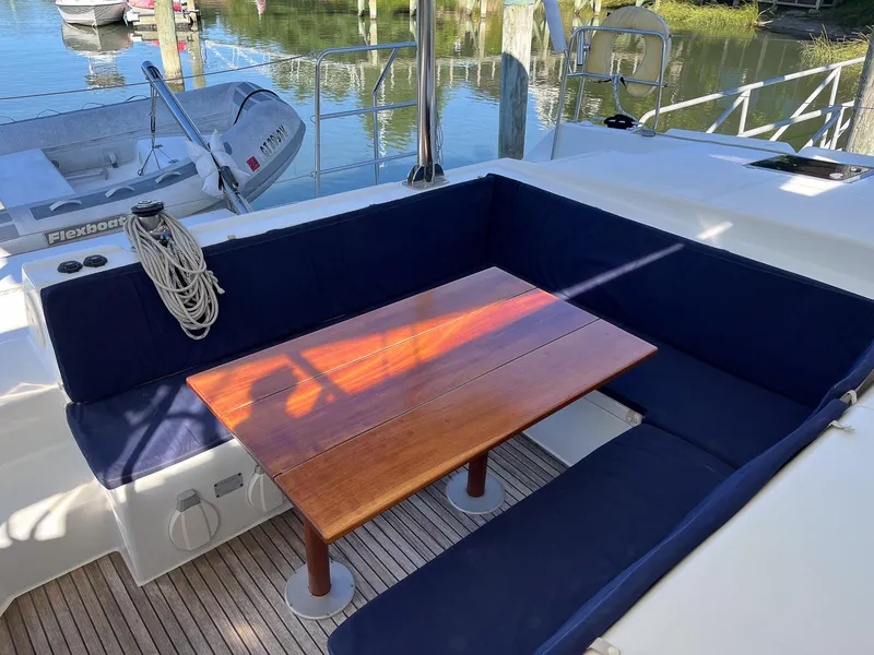 Slide: The Image of Lagoon 420 yacht deck with wooden table and navy seating, 2007 model. - 9
