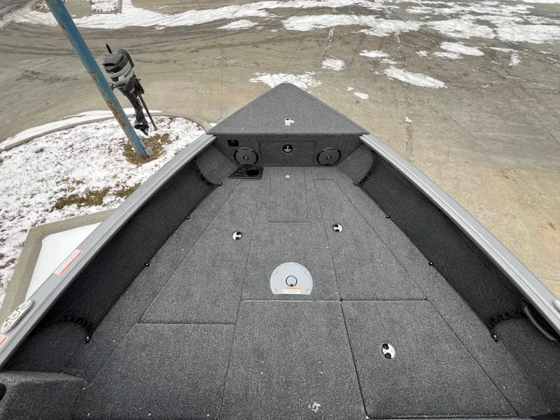 Slide: The Image of 2025 Lund 1875 Impact XS Sport boat deck in snowy outdoor setting. - 17