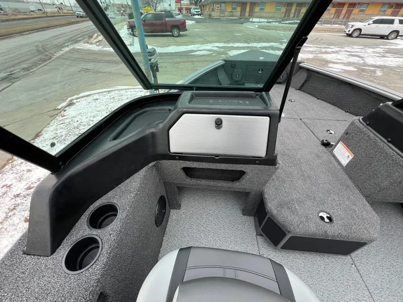 Slide: The Image of 2025 Lund 1875 Impact XS Sport boat interior with seating and storage compartments. - 19