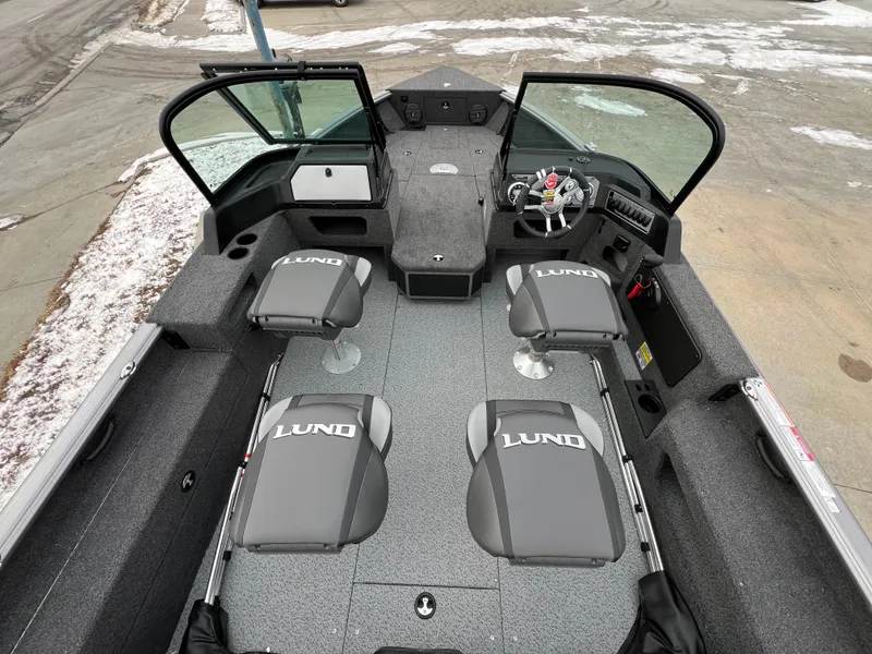 Slide: The Image of 2025 Lund 1875 Impact XS Sport boat interior with four seats and open windshield. - 20
