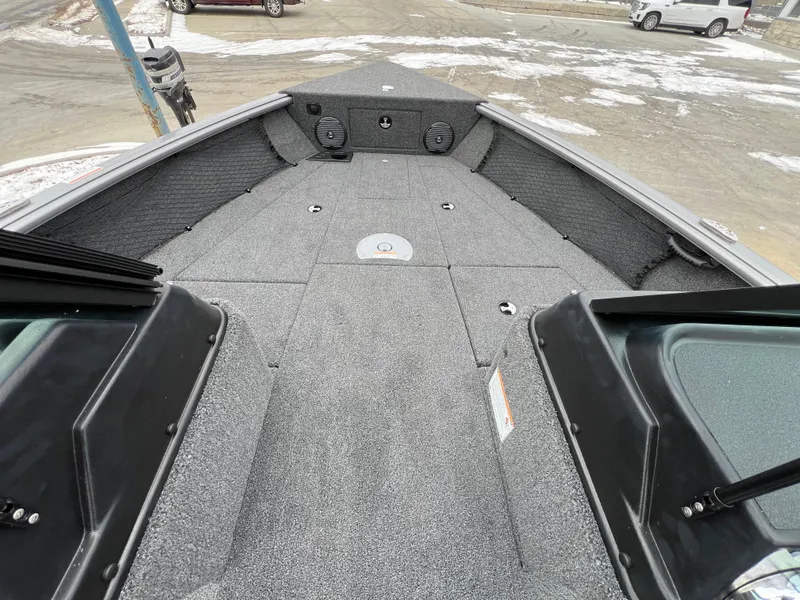 Slide: The Image of 2025 Lund 1875 Impact XS Sport boat interior with gray carpeted deck. - 22