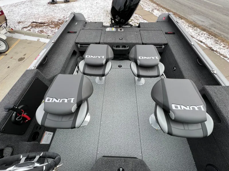 Slide: The Image of 2025 Lund 1875 Impact XS Sport boat interior with four gray seats. - 23