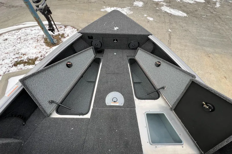 Slide: The Image of 2025 Lund 1875 Impact XS Sport boat interior with open storage compartments. - 24