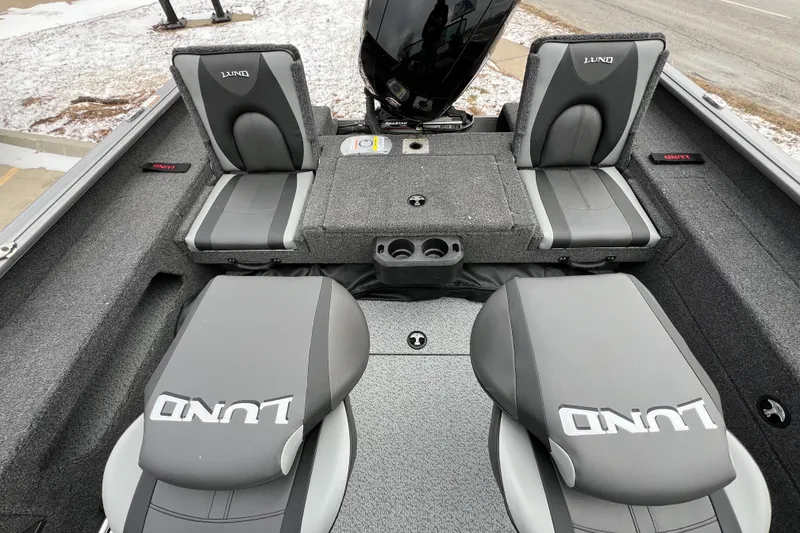 Slide: The Image of 2025 Lund 1875 Impact XS Sport boat interior with gray seating and storage compartments. - 25