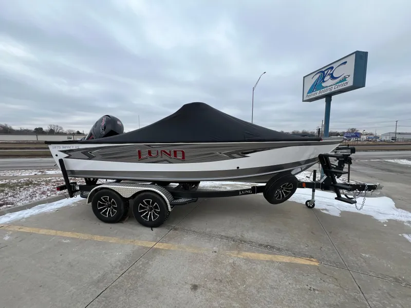 Slide: The Image of 2025 Lund 1875 Impact XS Sport boat on trailer, covered, parked outdoors. - 3