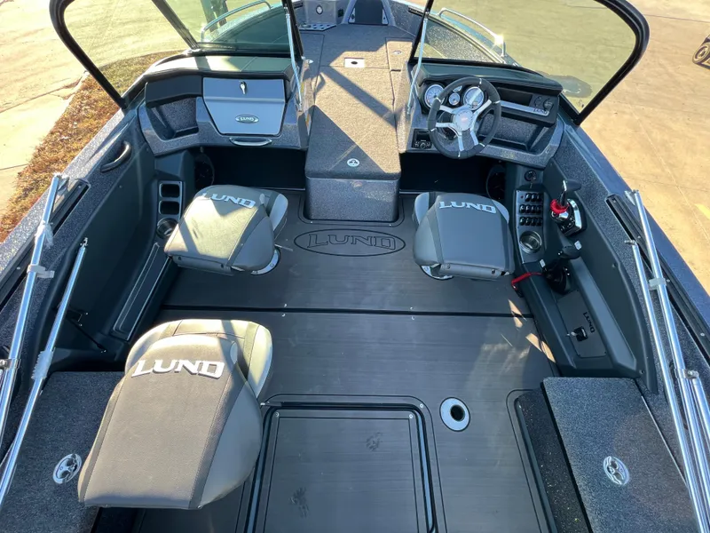 Slide: The Image of 2025 Lund 189 Pro-V GL boat interior with steering wheel and seating. - 14