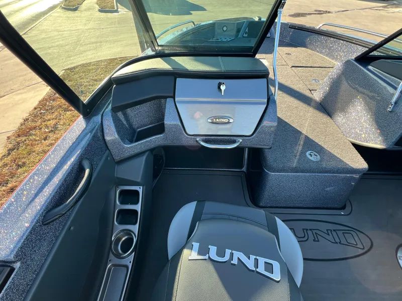 Slide: The Image of 2025 Lund 189 Pro-V GL boat interior with branded seating and dashboard. - 18