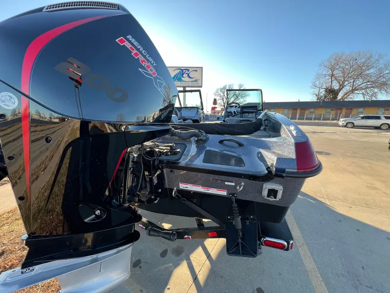 Slide: The Image of 2025 Lund 189 Pro-V GL boat with powerful outboard motor, parked outdoors. - 5