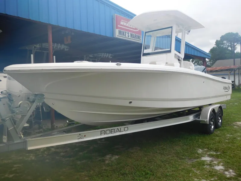 Slide: The Image of 2025 Robalo 246 Cayman boat on trailer at Mike's Marine dealership. - 2