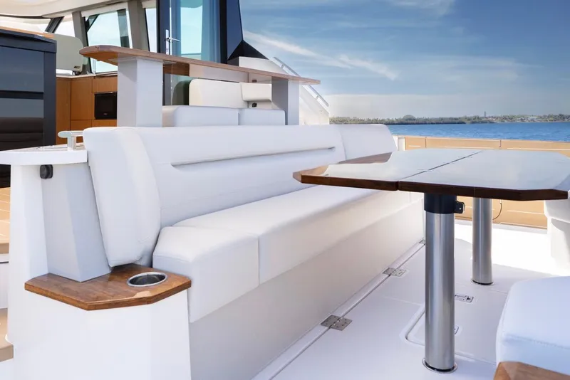 Slide: The Image of Luxurious seating area on 2025 Tiara Yachts EX 54, overlooking serene waters. - 10