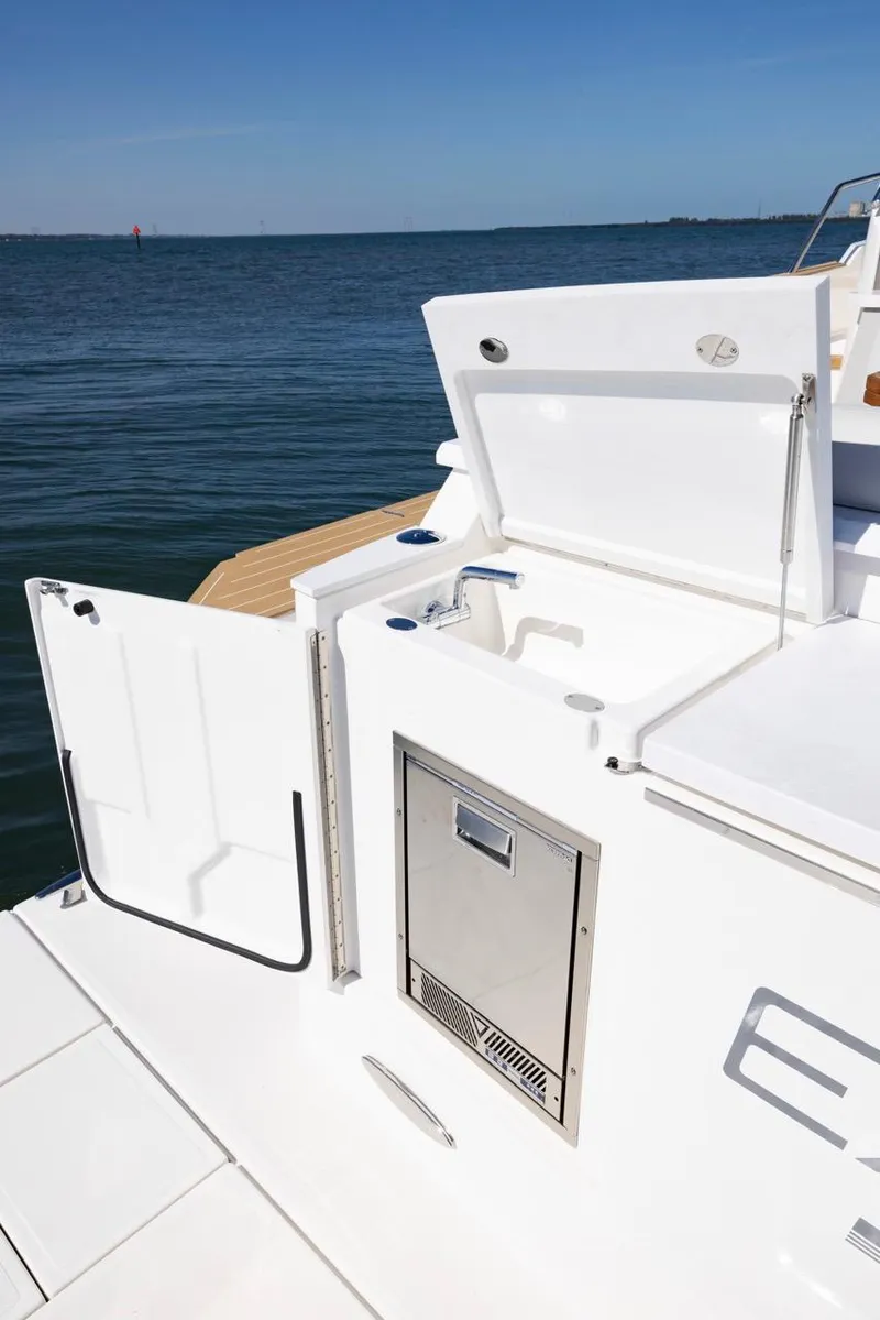 Slide: The Image of 2025 Tiara Yachts EX 54 deck with open storage, ocean view. - 12