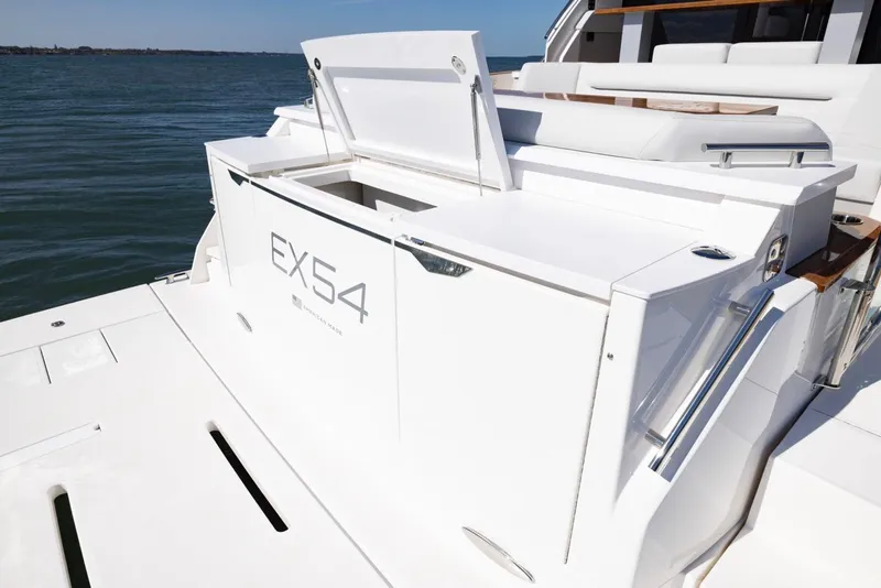 Slide: The Image of 2025 Tiara Yachts EX 54 luxury yacht deck with open storage compartment. - 15