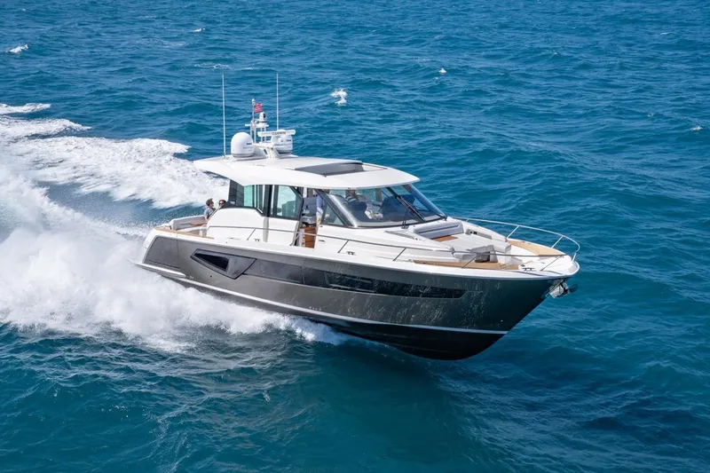 Slide: The Image of 2025 Tiara Yachts EX 54 cruising on open sea. - 2