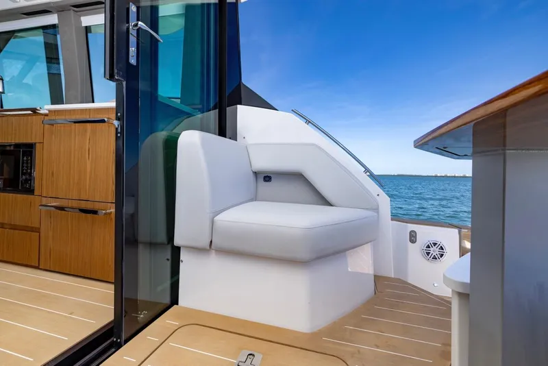 Slide: The Image of 2025 Tiara Yachts EX 54 interior with ocean view and modern seating. - 20