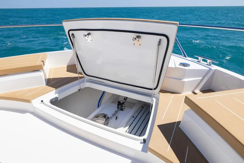 Slide: The Image of 2025 Tiara Yachts EX 54 open storage compartment on deck, ocean view. - 26