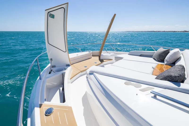 Slide: The Image of Luxurious 2025 Tiara Yachts EX 54 deck with sun loungers on open sea. - 29