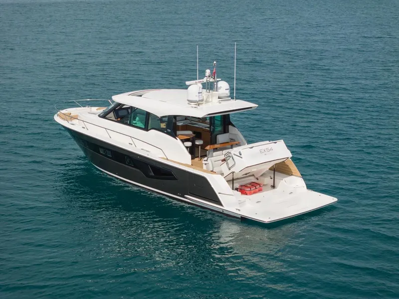 Slide: The Image of 2025 Tiara Yachts EX 54 luxury yacht cruising on open water. - 3