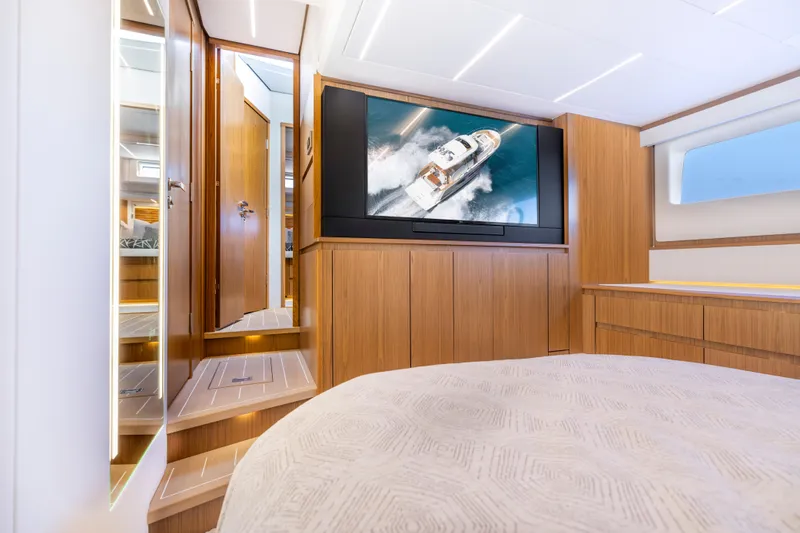Slide: The Image of Luxurious interior of 2025 Tiara Yachts EX 54 with wood paneling and large TV. - 38